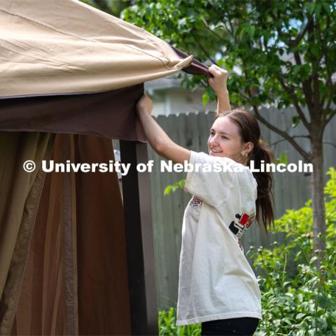 Alyssa Dunlap of Tri Delta attaches the outer curtain of a pergola during the Big Event. May 4, 2024. Photo by Kirk Rangel for University Communication.